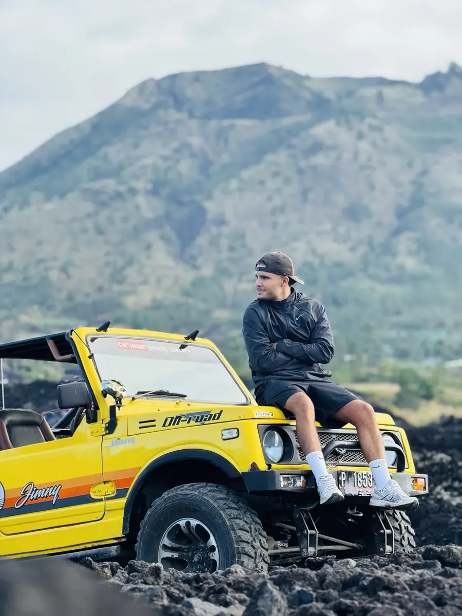 Guest with a yellow Jeep on Mount Batur black lava